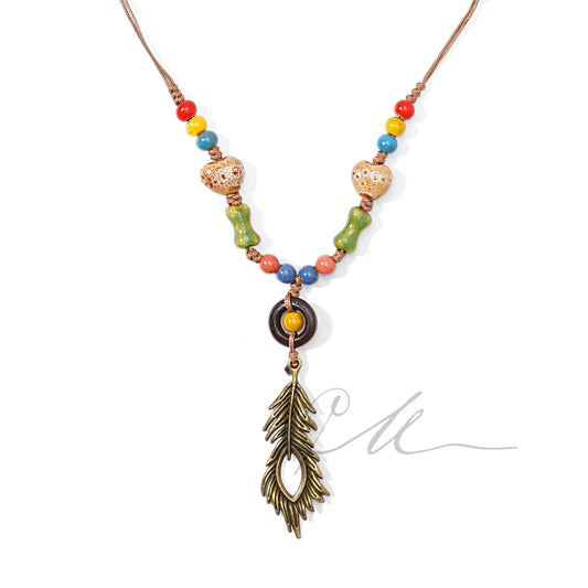 Solari | Boho Ceramic Necklace with Peacock Feather Charm